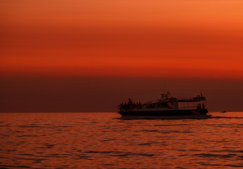 Fototapeta na wymiar Boat. Sky. Orange. Sun. Sea. Istria