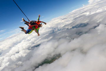 Naklejka na ściany i meble Tandem jump. The instructor and the student in free fall.