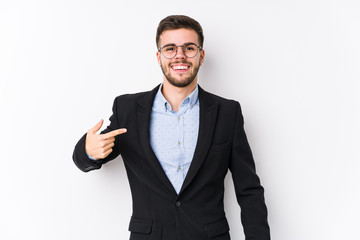 Young caucasian business man posing in a white background isolated Young caucasian business man person pointing by hand to a shirt copy space, proud and confident