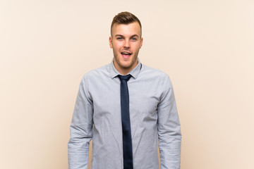 Young blonde businessman over isolated background with surprise facial expression