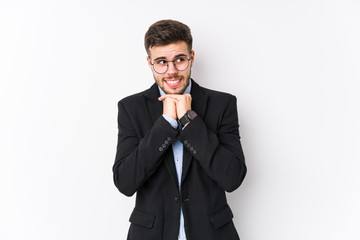 Young caucasian business man posing in a white background isolated Young caucasian business man keeps hands under chin, is looking happily aside.