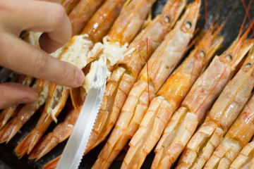 big prawns, seafood, vitamins. the process of cooking shrimp. the concept of cooking and healthy eating. a lot of fresh crayfish are lying on a plate, top view. seafood dish. tiger prawns with garlic