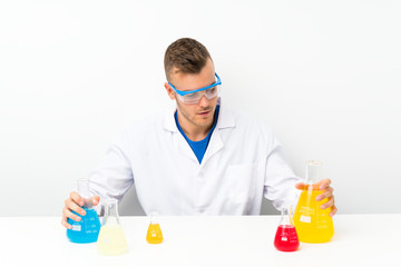 Young scientific with lots of laboratory flask