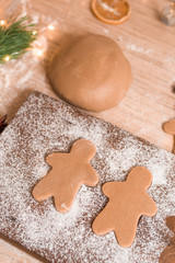 Gingerbread man cookies for Christmas holiday. process of manufacturing . close-up, space for text