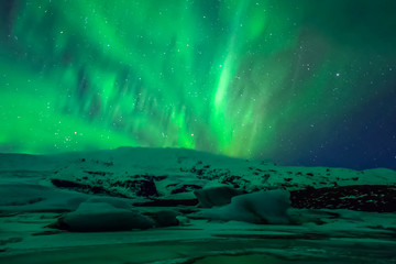 Aurora borealis in night northern sky. Ionization of air particl