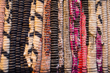  Close up of beautiful colorful hand made motley rug or carpet. Structure of fabric. Bright colored strips on diagonal.