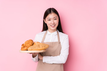 Young chinese baker woman isolated laughing and having fun.