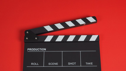 Obraz premium Clapperboard or clap board or movie slate .It is use in video production ,film, cinema industry on red background.