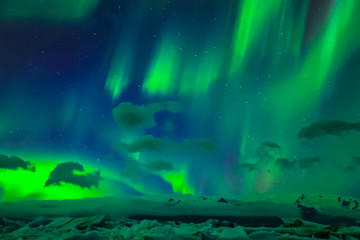 Fototapeta na wymiar Aurora borealis in night northern sky. Ionization of air particl