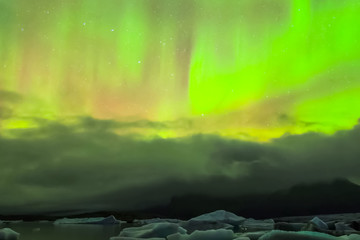 Aurora borealis in night northern sky. Ionization of air particl