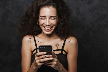 Image of nice happy woman smiling and using cellphone