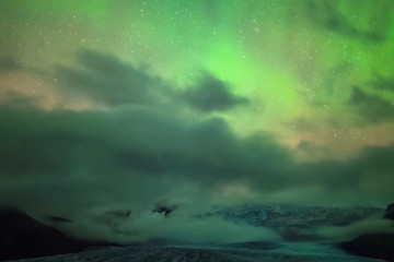Fototapeta premium Aurora borealis in night northern sky. Ionization of air particl