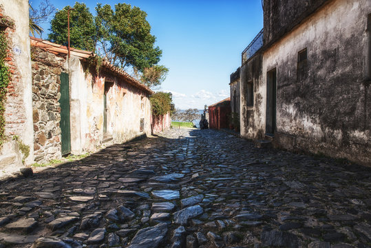 Stucco cottages on stone paved street in Colonia del Sacramento,