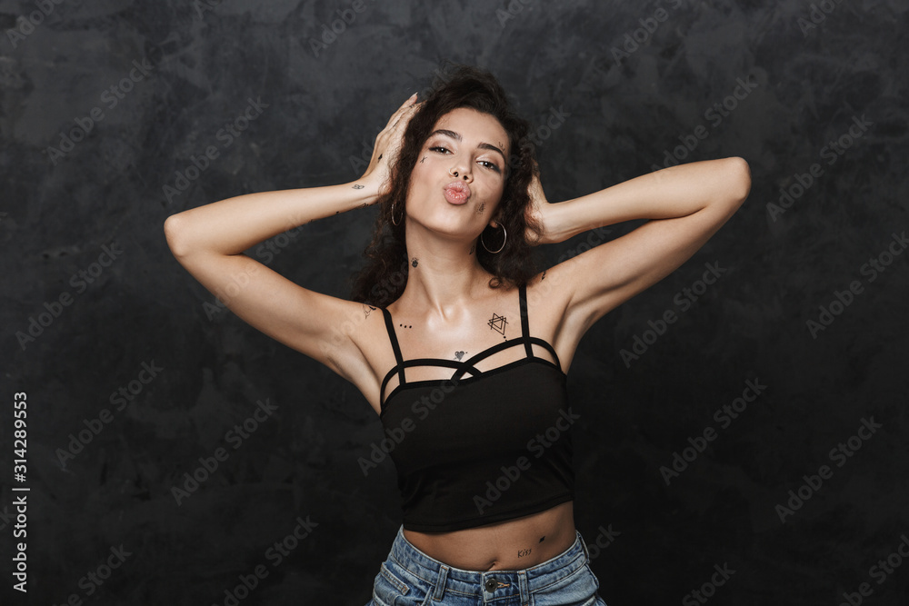 Sticker Image of young joyful woman making kiss lips and grabbing her head