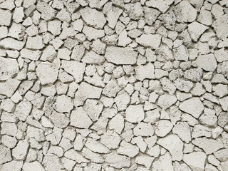 Texture of concrete in grey tone with cracked surface and dirt in cracks.old gray concrete wall for background. Concrete texture in white tone with very rough surface and large, deep cracks.