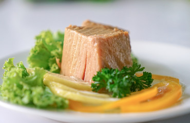 Tuna chunk on white plate.