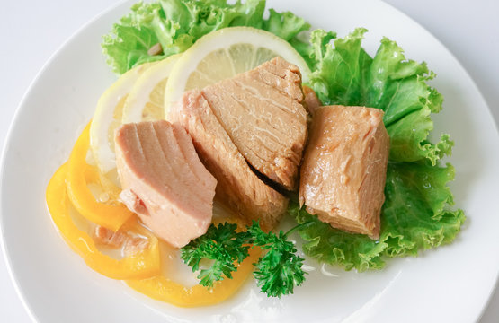 Tuna chunk on white plate.