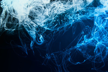 Fine structure of ink dissipating dissolving in water media. Photo tinted with blue color.