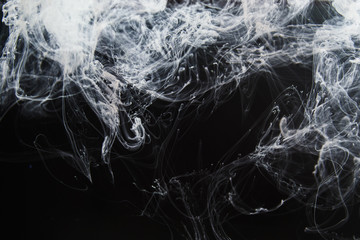 Abstract background with fine structure of white fume smoke traces on black background.