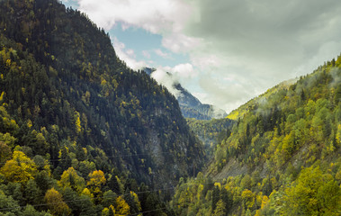Fototapeta premium Mountain slopes covered with forests and low thunderclouds in Svaneti in the mountainous part of Georgia