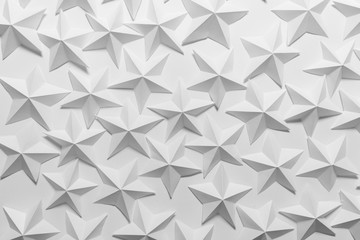 Abstract backgound with white handmade origami folded paper stars on white backgound.