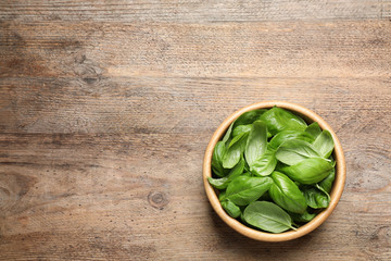 Fresh basil on wooden table, top view. Space for text