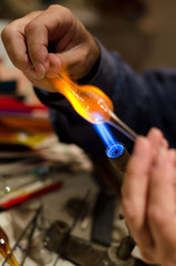 Craftsman is making figures of melted glass. Handmade and craft production.