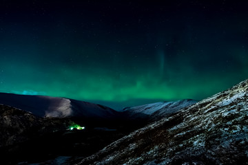 Naklejka na ściany i meble Aurora borealis in night northern sky. Ionization of air particl