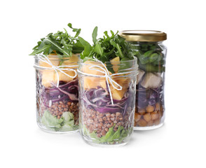 Glass jars with healthy meal isolated on white