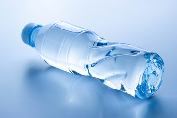 Plastic bottle lay down on white background.