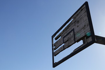 Old basketball backboard. Lens flare.