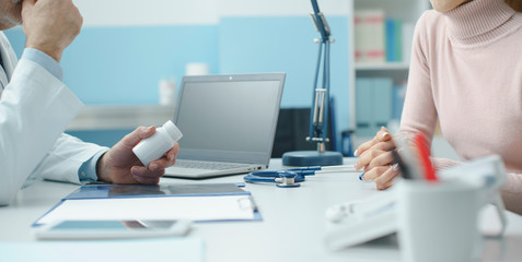 Professional doctor giving a prescription medicine to a patient