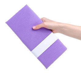 Purple folded pillowcases in hand on white background isolation