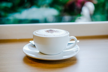 hot cappuccino latte coffee on wood table.