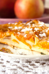 Homemade fruit apple apricot peach pie on white crochet napkin on white rustic table background
