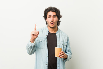 Young cool man drinking a coffee having some great idea, concept of creativity.