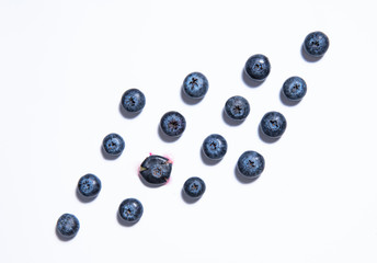 pattern of fresh blueberries is laid out on a white background