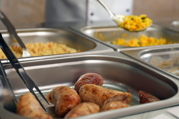 Containers with tasty food in school canteen