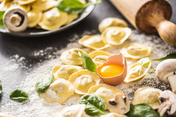Raw ravioli with flour egg musrooms and and spinach. Italian or mediterranean healthy cuisine