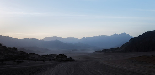 night desert landscape with rocky mountains and sunset sky with clouds in Sharm El Sheikh