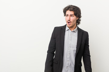 Young business man against a white background being shocked because of something she has seen.