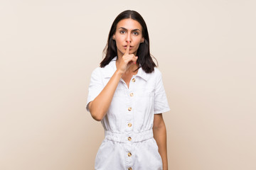 Young woman over isolated background showing a sign of silence gesture putting finger in mouth