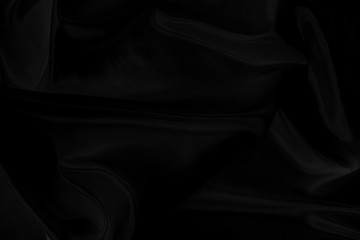 Black gray satin dark fabric texture luxurious shiny that is abstract silk cloth background with patterns soft waves blur beautiful.