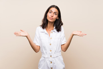 Young woman over isolated background making doubts gesture