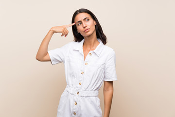 Young woman over isolated background making the gesture of madness putting finger on the head