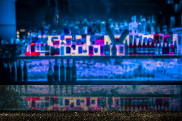 Desk of free space and blurred bar interior 