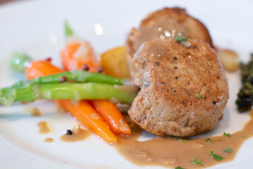  pork steak with sauce on white plate