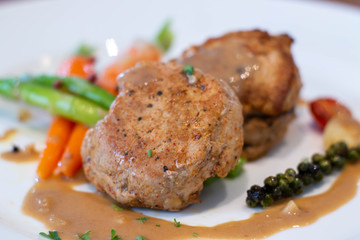  pork steak with sauce on white plate