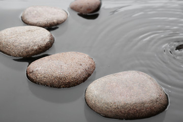 Fototapeta na wymiar Beautiful spa stones in water. Zen lifestyle