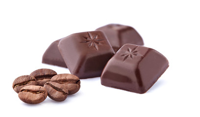 Coffee beans and dark chocolate on white background